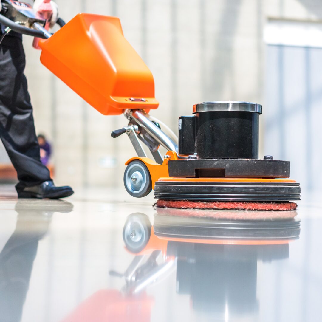 commercial floor buffer going across a shiny floor